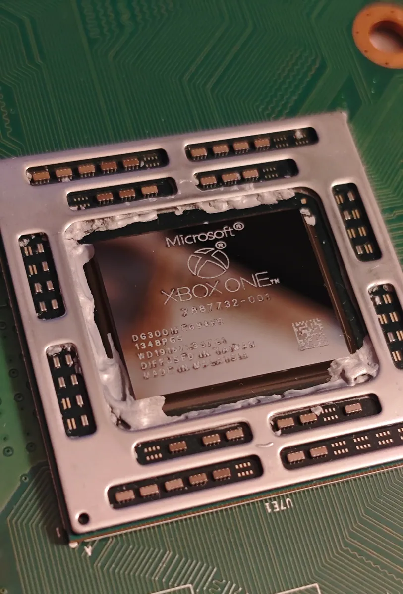 Xbox One processor cleaned to a shiny surface, showing the Microsoft Xbox One markings